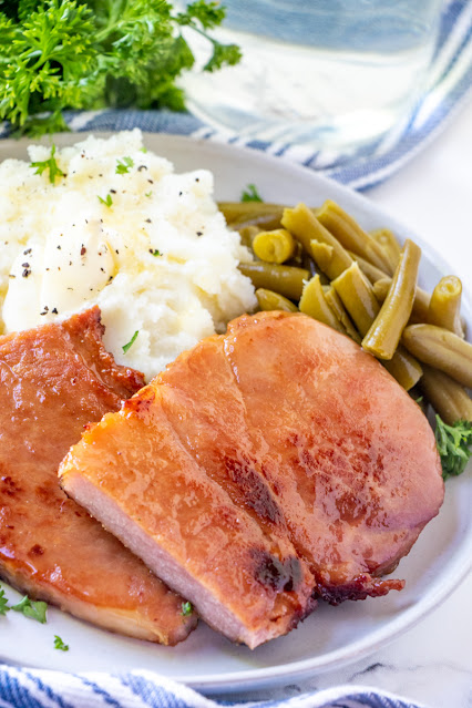 This old fashioned easy and tasty ham steak is great for breakfast or dinner! The brown sugar and butter combo makes a delicious sauce that goes perfectly with the salty taste of ham. This family favorite recipe is sure to be a hit!