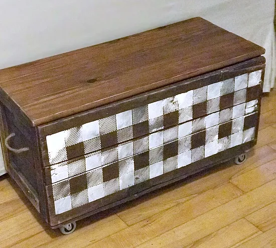 Vintage rolling crate with buffalo check stencil.