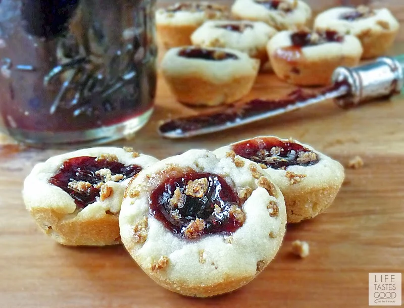 Jam Thumbprint Cookies | by Life Tastes Good are blissful little cookie bites. My jam thumbprint cookies are crunchy, and filled with any kind of jam you like best! They are a Christmas tradition in our house! Santa loves these cookies too!