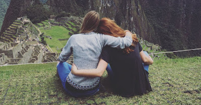 Two women travellers in solidarity in Machu Picchu, near Cusco.