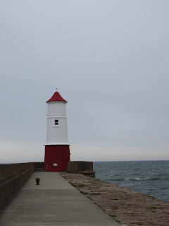 Berwick Lighthouse, a red and white lighthouse on the end of a pier in Berwick upon Tweed.  Photo by Kevin Nosferatu for the Skulferatu Project.  Photo by Kevin Nosferatu for the Skulferatu Project.