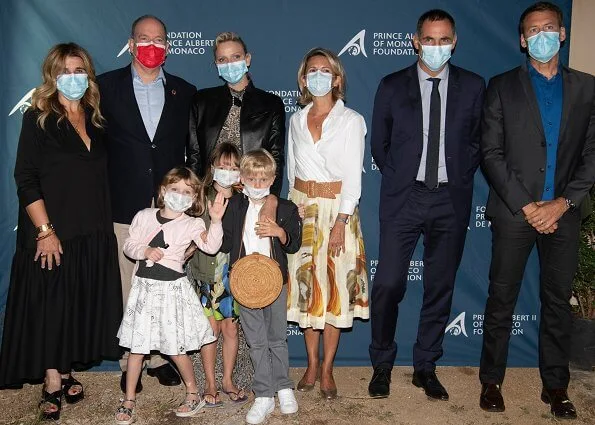 Prince Albert and Princess Charlene of Monaco and their children Prince Jacques and Princess Gabriella. Brunello Cucinelli silk blouse. Jacadi skirt