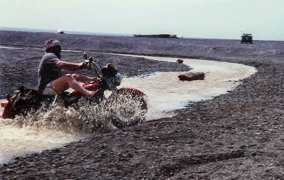 Man on Shovelhead motorcycle riding through water