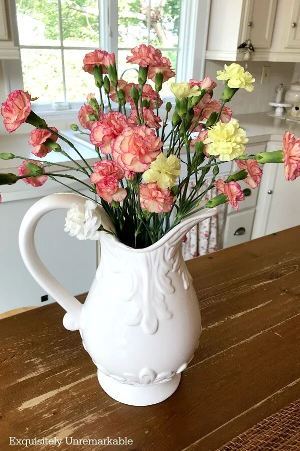 Large White Pitcher with pastel carnations