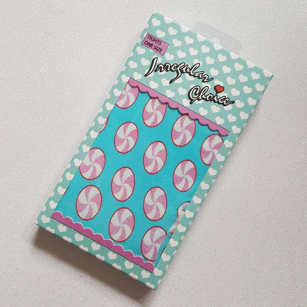 pastel coloured tights in packet with candy swirl lollipops