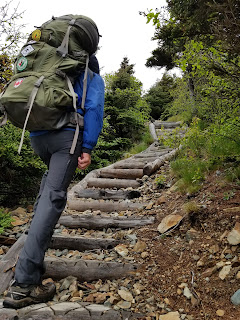 Sean Morton beginning East Coast Trail climb up wooden stairs.