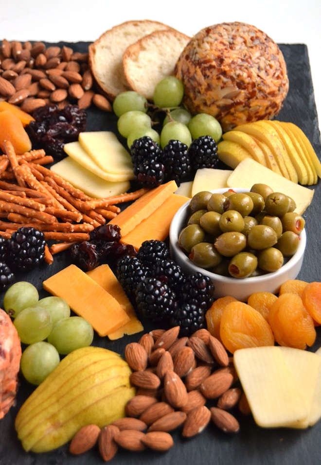 The Ultimate Cheese Board is perfect for entertaining, takes 5 minutes to put together and is filled with your favorite cheeses, nuts, dried fruits, crackers, olives and more! www.nutritionistreviews.com