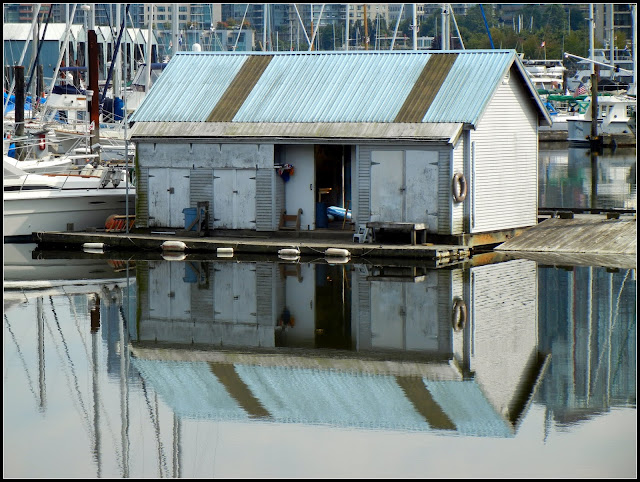 A boathouse reflection in the harbor in Vancouver, British Columbia