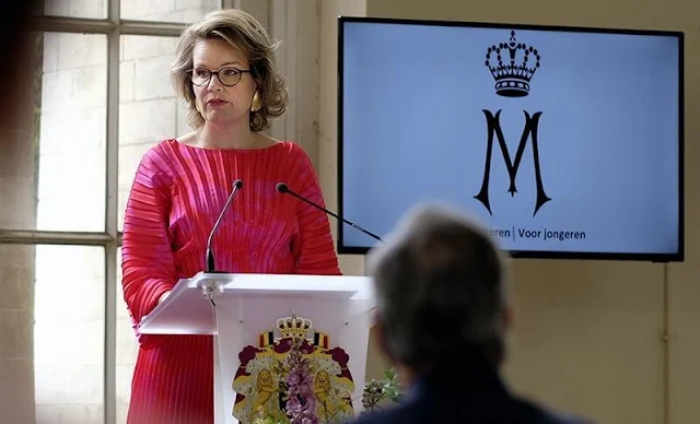 Queen Mathilde wore a new flare pleated red midi dress from Natan. Delphine Nardin gold earrings. Tikli Jewelry gold bracelet