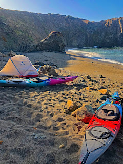 Tent with sea kayaks on a beach on the Mendocino Coast of California