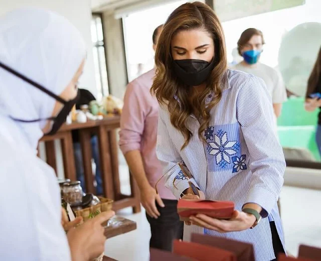 Queen Rania wore a blue embroidered design, striped, long sleeve blouse shirt from Maison Makarem, black denim trousers