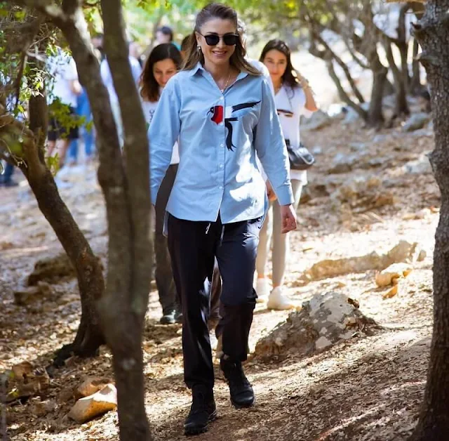 Queen wore her Salomon hiking shoes, Saint Laurent sunglasses and Nike pants, She wore a new embroidered blue shirt