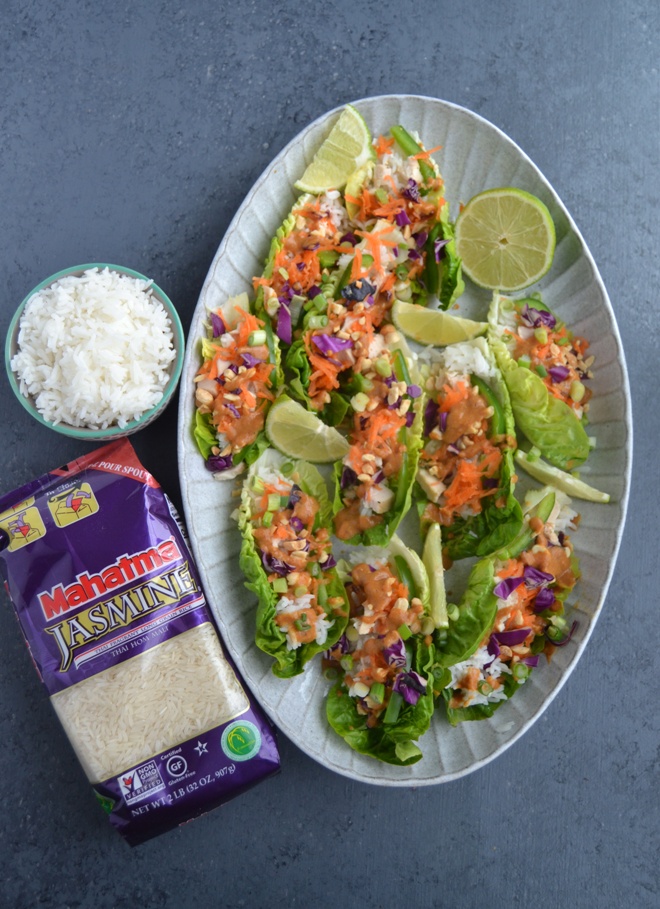 Peanut Chicken Lettuce Wraps are loaded with thinly sliced grilled chicken, red cabbage, carrots, jasmine rice, green onions, peanuts, lime juice and a flavorful peanut sauce! www.nutritionistreviews.com