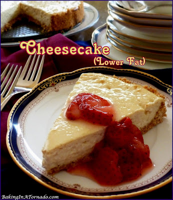 This Cheesecake is lower in fat but just as creamy and delicious as the full fat version. Serve as is or top with fruit of your choice. | Recipe developed by www.BakingInATornado.com | #recipe #dessert