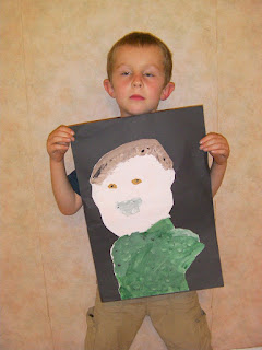 kid posing with painting of self