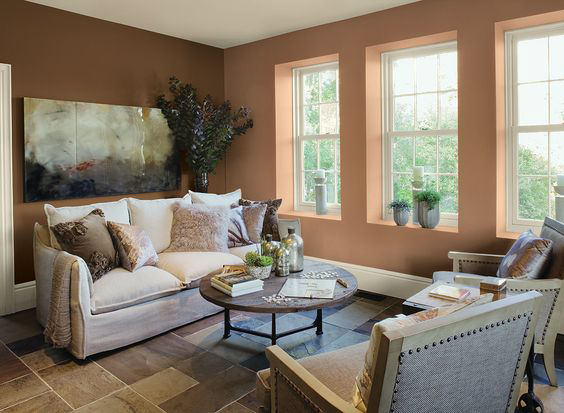 living room with cozy sofa and throw pillows and walls painted with Benjamin Moore Potters Clay