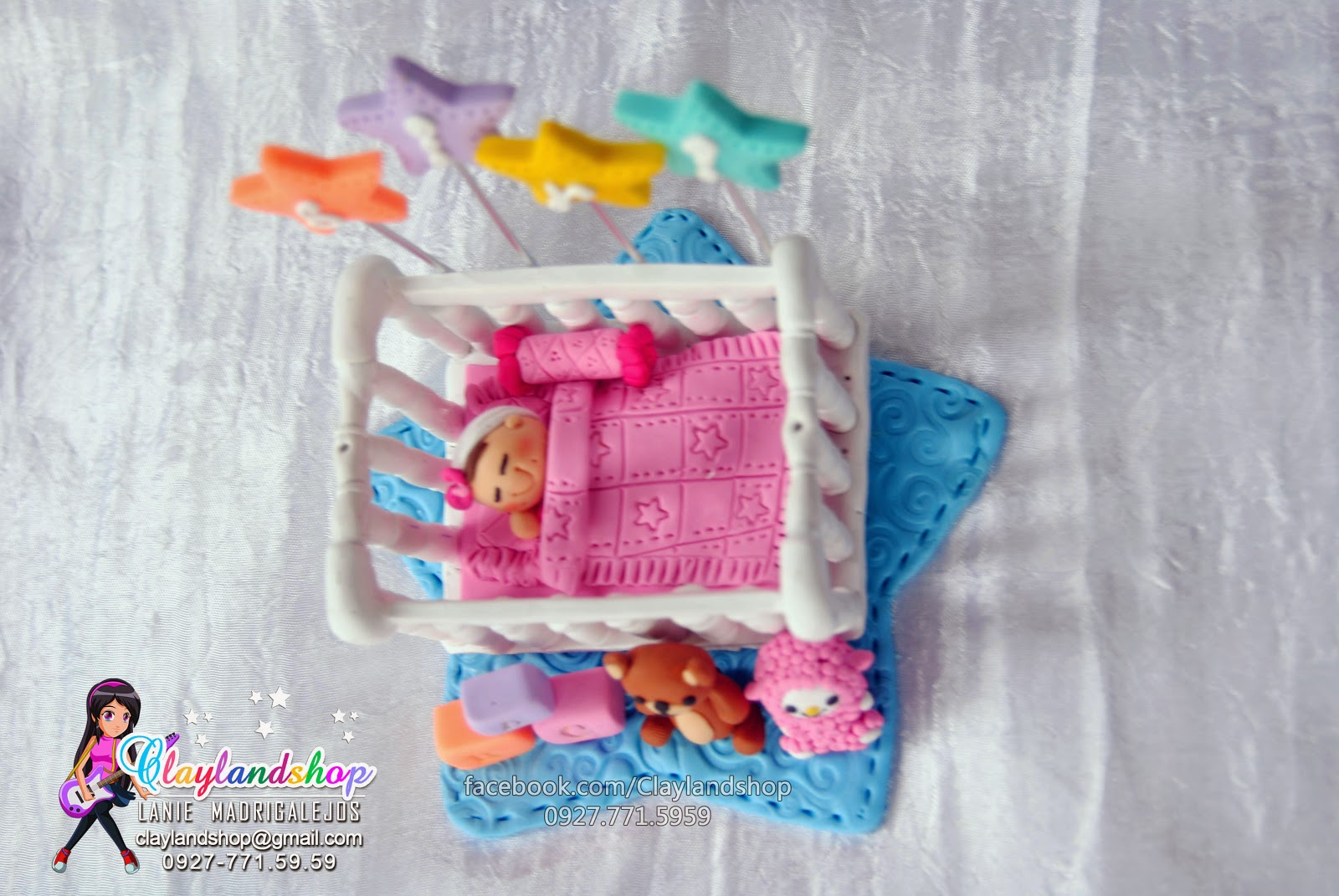 Clayland Souvenir Shop Baby sleeping in a crib cake topper