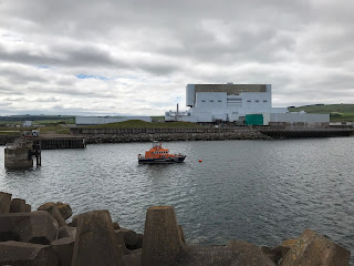 Torness Nuclear Power Station as seen from the walkway pier - at the front of the picture are the concrete Dolos leading down to a bay in which sits a lifeboat and on the other side of the water is the power station.  Photo by Kevin Nosferatu for the Skulferatu Project