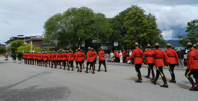 The RCMP parade leaves the ceremony while the families watch