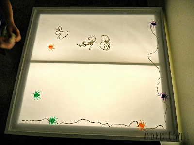 Building a giant spiderweb on the light table from And Next Comes L