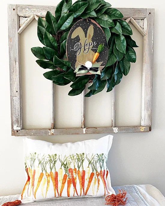 Old window with wreath and carrot pillow