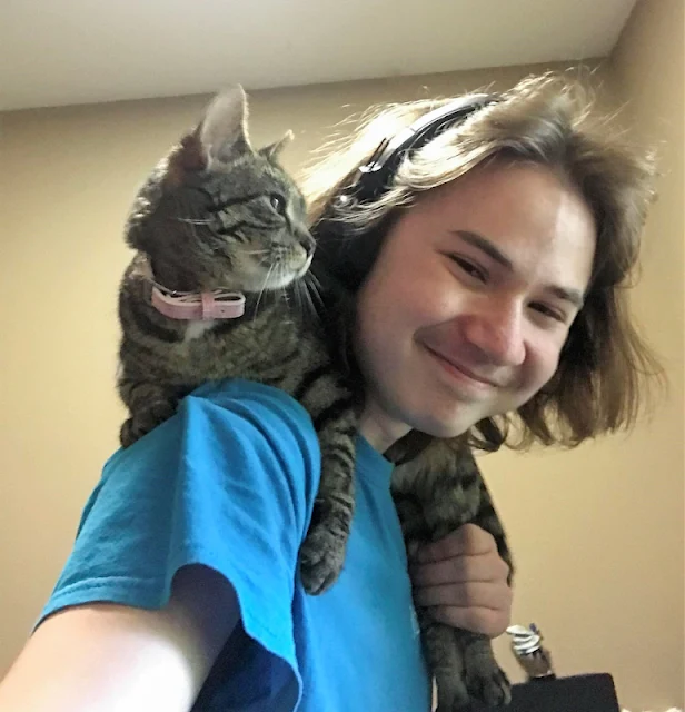 Picture of a cat and a young man.