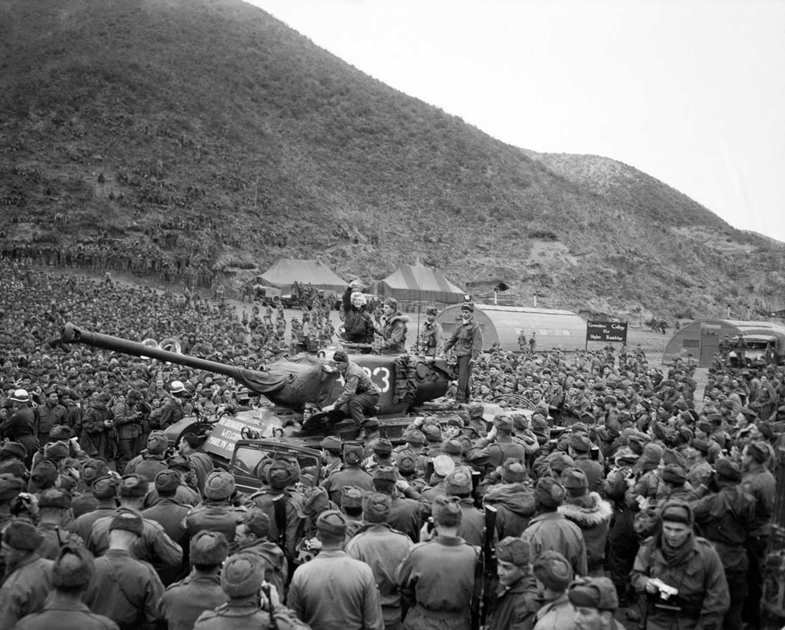 Troops on a tank for a better view.