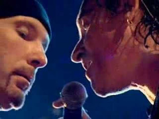Bono & The Edge close-up singing