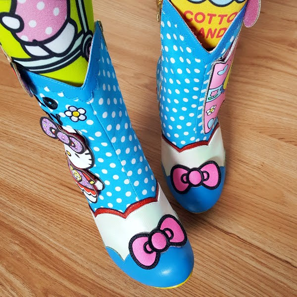 wearing blue polka dot boots with pink Hello Kitty bow across toe