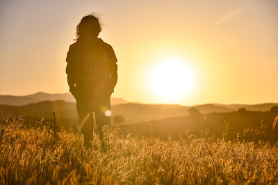 Beautiful Girl standing in a farm. Grassland hills photo