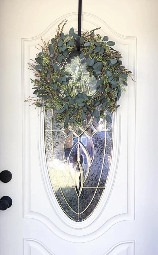 wreath on front door with oval window