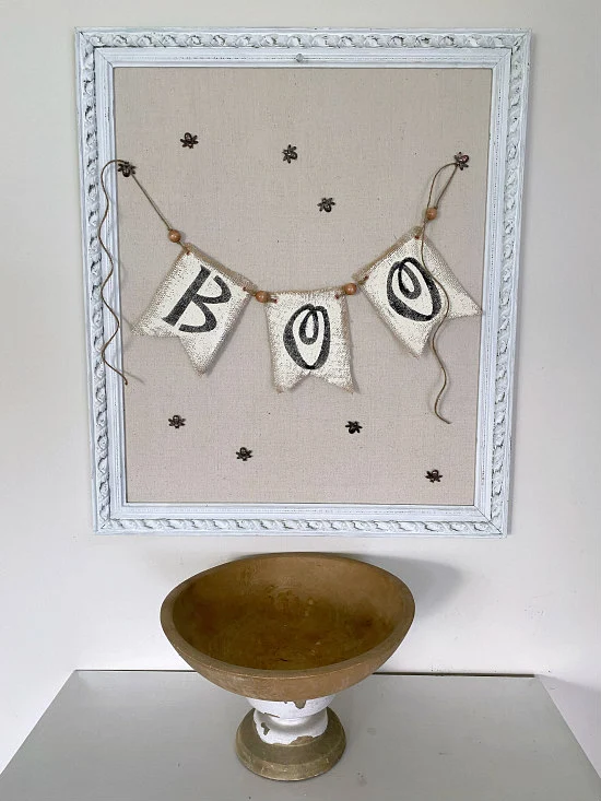 Wooden bowl and framed bulletin board with boo banner