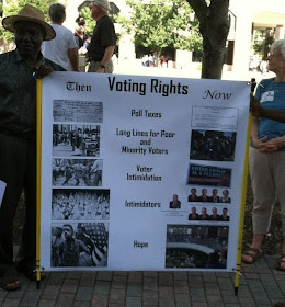 This picture shows a man holding a sign explaining the reduction in state voting rights.