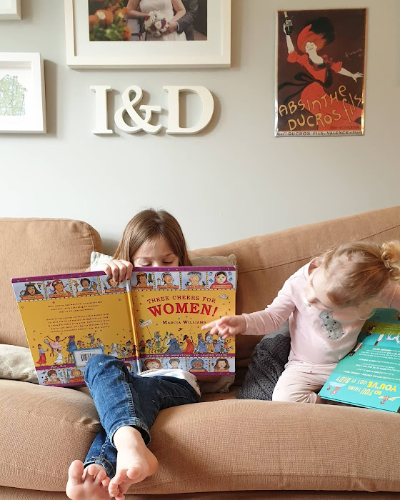 girl reading a book on sofa