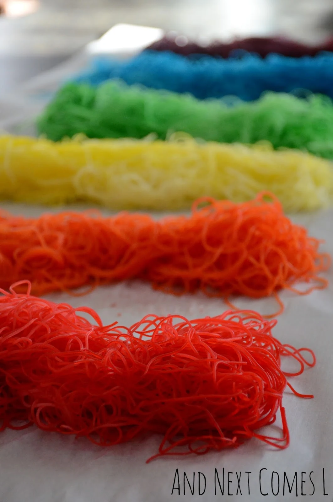 Rainbow dyed rice noodles for sensory play from And Next Comes L