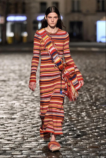 The woman wore a knit dress with striped element.