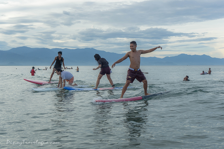 Surfers riding at Sabang Beach, Baler