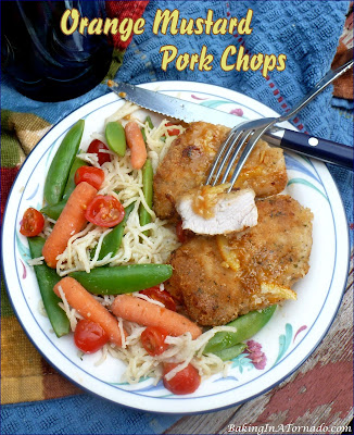 Orange Mustard Pork Chops, lightly marinated, crusted, oven “fried” pork chops served with a sweet hot citrus sauce. | recipe developed by www.BakingInATornado.com | #recipe #dinner