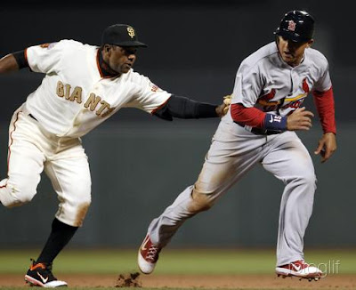 San Francisco Giants shorts stop Miguel Tejada (L) tags out St. Louis Cardinals baserunner Jon Jay (R) after Jay attempted to steal second base during the top of the eighth inning of their MLB National League baseball game in San Francisco, California, April 9, 2011. REUTERS/Beck Diefenbach