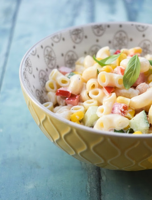 Creamy macaroni salad in a yellow bowl