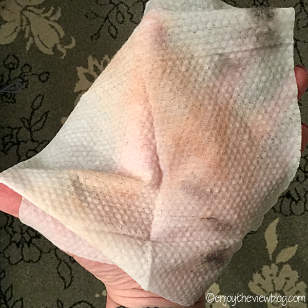 a used Simple® Cleansing Facial Wipes lying across a palm