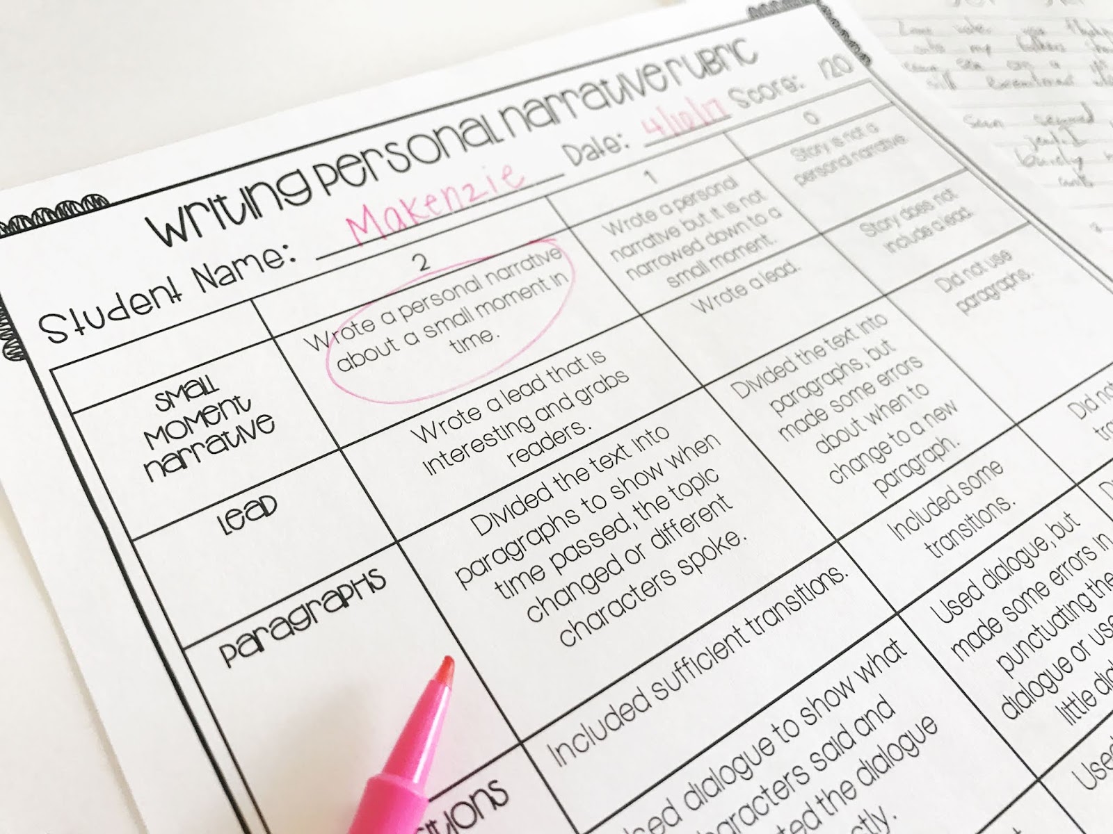 Writing rubric with pink flair pen is great for giving students feedback about their writing
