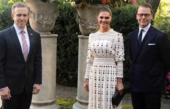 Crown Princess Victoria wore a new multicolor midi dress from By Malina. By Malina Maisy dress. Quidam clutch. exhibition of Alice Aycock