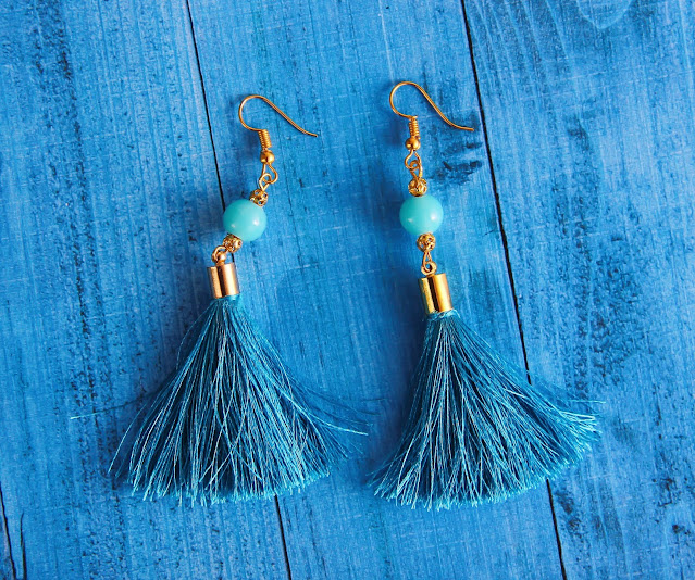 A pair of blue tassle dangling earrings.