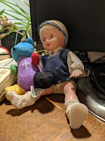 Speaking of praying across difference, Finland Doll in dark blue shirt and white other clothes wonders how she wound up next to the blue bear dud with the big white cross on his purple shirt