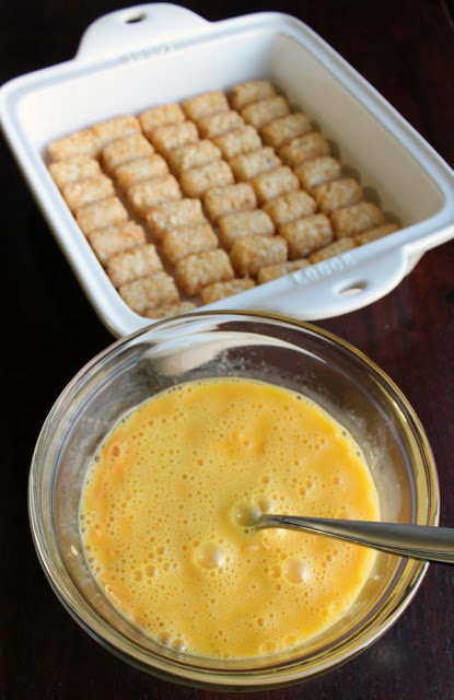 pan of arranged tater tots and bowl of beaten eggs ready to be made into breakfast bake
