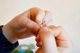Piercing thread into needle