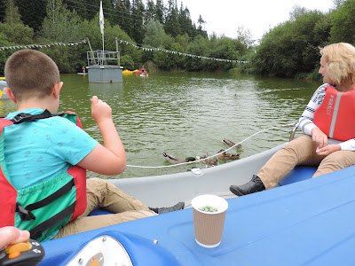 electric boat hire on centre parcs lake feeding ducks from a boat longleat