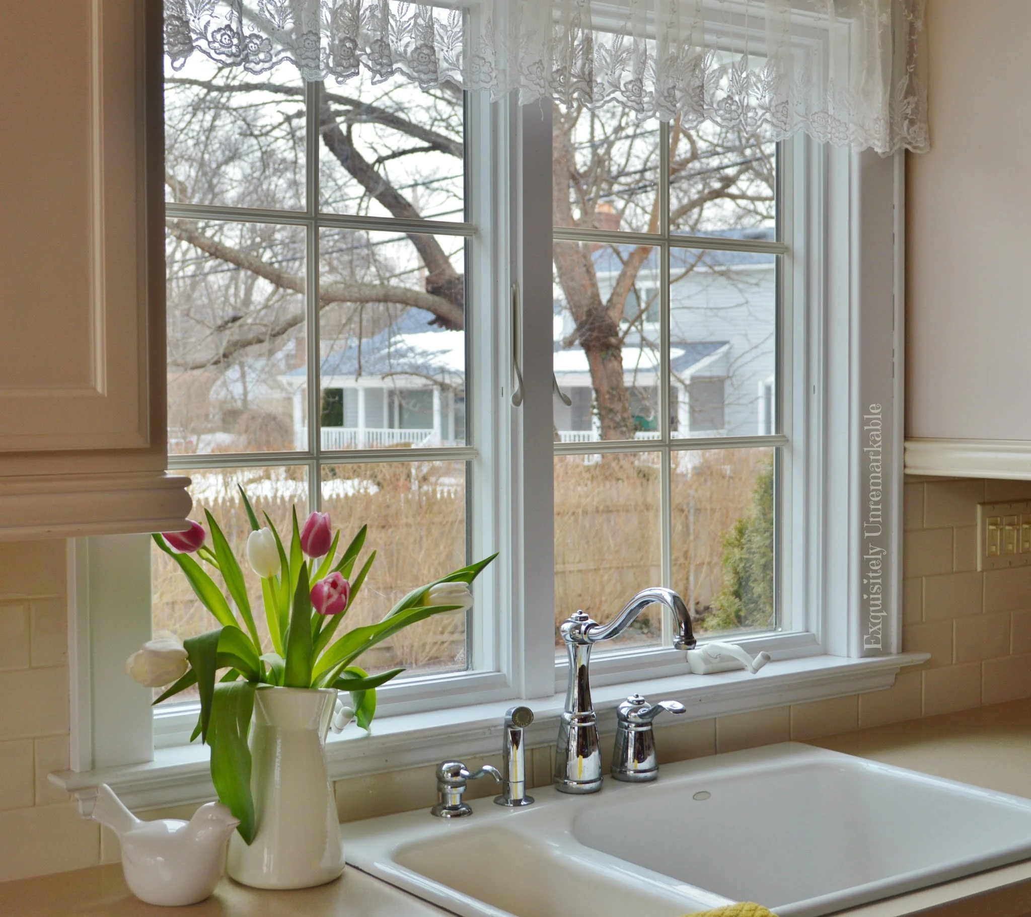 White kitchen sink by a window