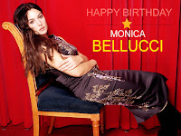 monica bellucci birthday, seated on chair with long skirt and long boots